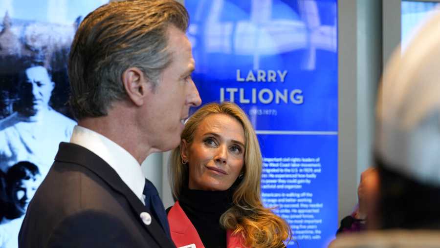 California Gov. Gavin Newsom talks to reporters after he and his wife, first partner Jennifer Siebel Newsom, right, voted in Sacramento, Calif., Tuesday, Nov. 8, 2022. Newsom is running for reelection against Republican state Sen. Brian Dahle. (AP Photo/Rich Pedroncelli)