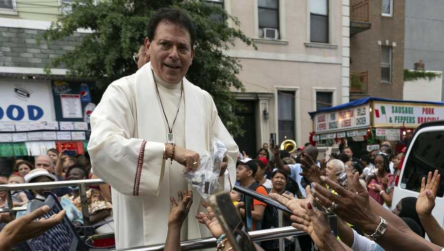 FILE- Former pastor of Shrine Church of Our Lady of Mount Carmel Monsignor Jamie Gigantiello speaks with parishioners, July 16, 2022, in the Brooklyn borough of New York. (AP Photo/Julia Demaree Nikhinson), File