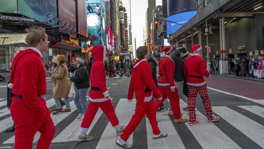 Revellers take part in SantaCon, on Saturday, Dec. 14, 2024, in New York. (AP Photo/Julia Demaree Nikhinson)