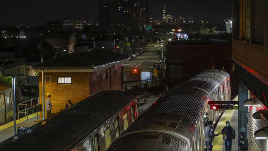 FILE - New York Police officers clear a train at the Coney Island Stillwell Avenue Terminal, May 5, 2020, in the Brooklyn borough of New York. (AP Photo/Frank Franklin II, file)