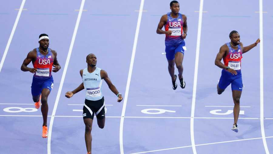 Botswana's Letsile Tebogo, USA'sKenneth Bednarek and USA's Noah Lyles cross the finish line to finish first, second and third respectively in the men's 200m final of the athletics event at the Paris 2024 Olympic Games at Stade de France in Saint-Denis, north of Paris, on August 8, 2024. (Photo by Odd ANDERSEN / AFP) (Photo by ODD ANDERSEN/AFP via Getty Images)